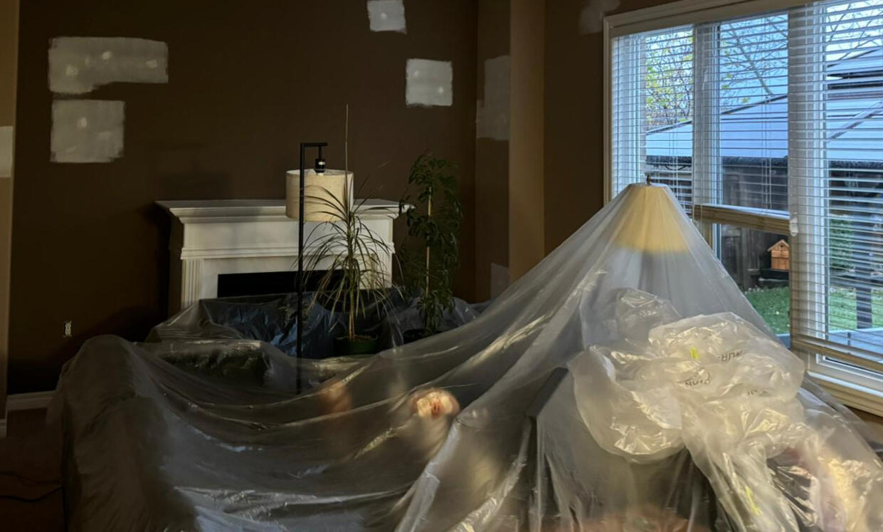 Living room preparation, plastic covering of all furniture